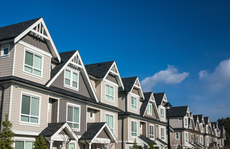 rental properties against a blue sky with clouds