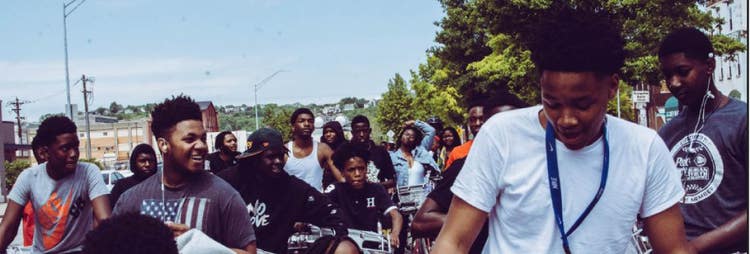 crowd of african american children riding bicycles