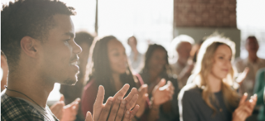 A crowd of people giving a standing ovation