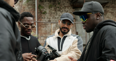 a crew standing together discussing filming a movie