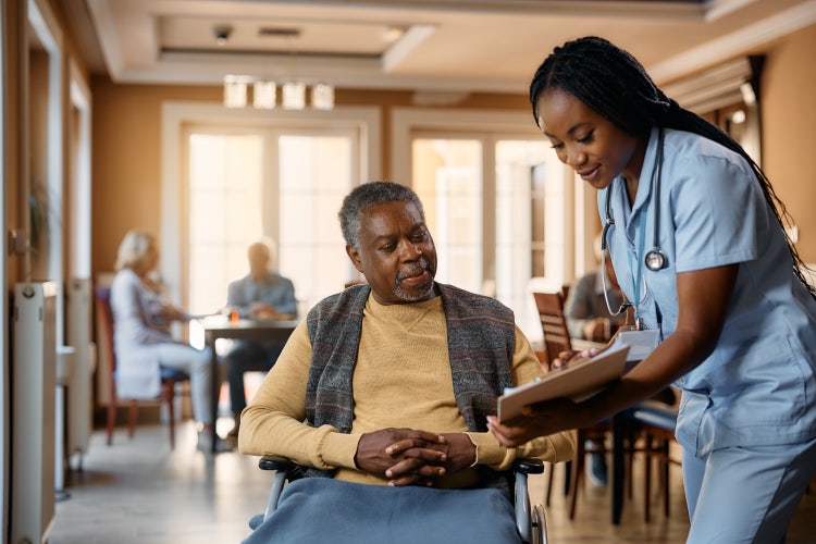 a nurse addressing her patient's chart with said patient