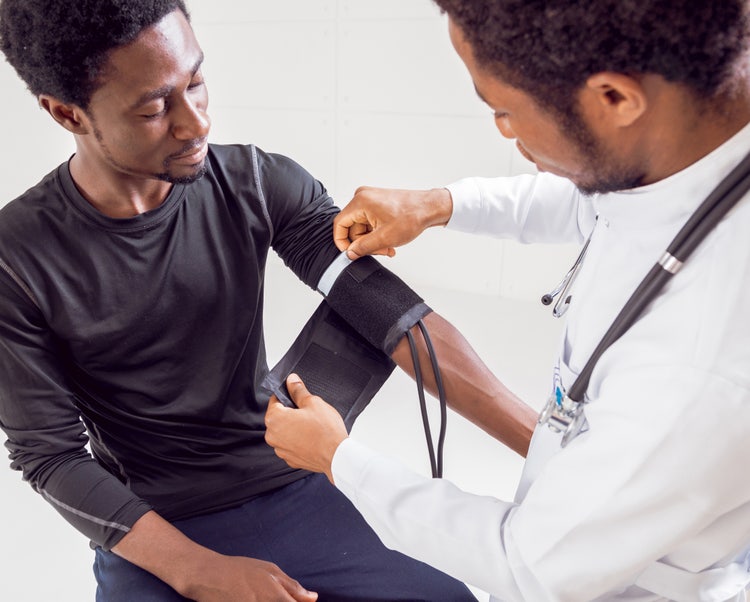 a doctor taking his patient's blood pressure