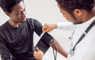 a doctor taking his patient's blood pressure