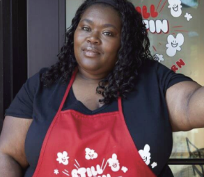 A woman standing in front of her popcorn business