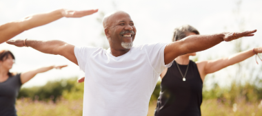 a group of people performing the warrior pose